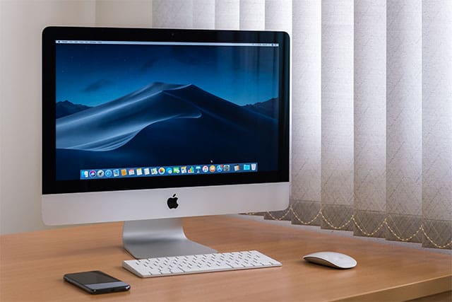 An image featuring an MacOS device with a mac keyboard and mouse