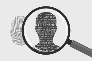 An image featuring a fingerprint that has a magnifying glass on top of a man's silhouette with personal information inside representing personal data concept
