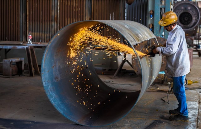 man working big steel pipe