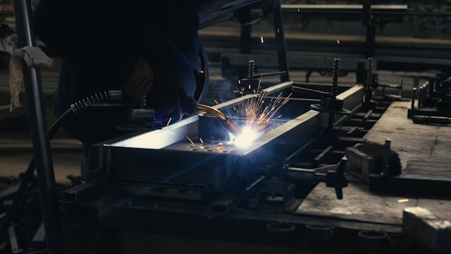 welder fuses metal components